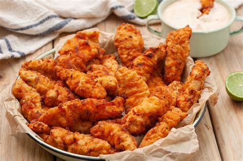 Spicy chicken strips. Cut the chicken into strips the size you prefer. Place the chicken fingers in the flour mixture. Shake away any excess flour from each piece of chicken before coating it in the egg mixture. Preheat your deep fryer to 375 degrees, or alternatively heat a small pot filled half way with oil over medium high heat. 