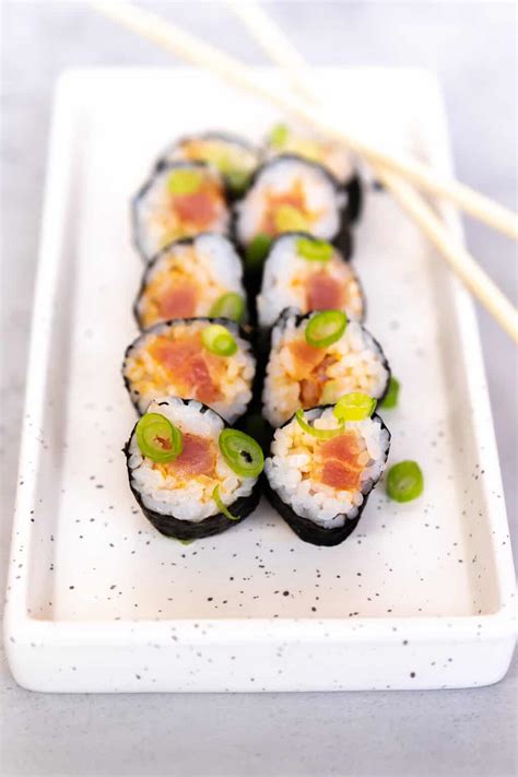 Spicy tuna roll. Learn how to make a classic sushi roll with spicy tuna and cucumber, wrapped in seaweed and rice, and served with soy sauce and wasabi. Follow the easy steps and watch the video to see the process. 
