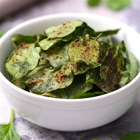 Spinach chips. Preheat your air fryer to 375°F and lightly coat your fresh spinach leaves with some olive or avocado oil. Season with salt and pepper to taste before adding them to the preheated air fryer basket. Cook for about 5-7 minutes, making sure to shake the basket every few minutes to ensure even cooking. 