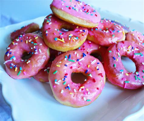 Sprinkles donuts. Preheat oven to 325 degrees. Spray a donut pan with cooking spray. Whisk the egg and egg whites together. Add the almond milk, apple sauce, vanilla extract, and stir. In a separate bowl, mix the dry ingredients, then add to the wet ingredients. Spoon the batter into the donut molds. 