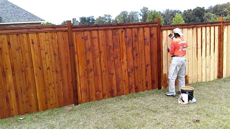 Staining a fence. For the most part, a pressure wash should be enough to remove dirt and old stain residue on the fence. If the fence is dull or discolored, consider applying a coat of wood brightener to restore the original color. 2. Get yourself ready. DimSan/Shutterstock. 