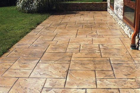 Stamped concrete cost. Find a Contractor. Stamped concrete patterns are used to create the look of brick, slate, flagstone, cobblestone or other patterns on your concrete patio, driveway or other surface. These patterns are a cost-effective way to achieve realistic looking textures. 