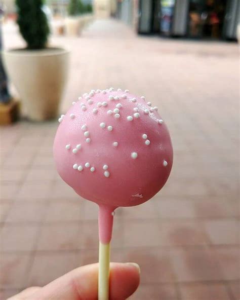Starbucks cakepop. Frosted Doughnut Cake Pop ... Vanilla cake shaped into a mini doughnut, dipped in a rich, chocolaty coating, frosted with a ring of pink or a ring of white, then ... 