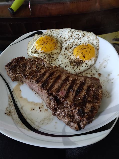 Steak n eggs. Deglaze the pan with the white wine, and a splash of water. Add the mustard, stirring well until the sauce becomes slightly thicker. Season with more black pepper, and salt if necessary. Place a smaller non-stick pan over medium heat, once hot, add a drizzle of olive oil, then fry your eggs. Season with salt and pepper. 