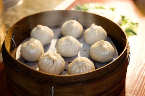 Steaming dumplings. directions · Mix together pork, green onions, cilantro, ginger, mushrooms, soy sauce, sesame oil, sugar, cornstarch and egg white in a large bowl until well ... 