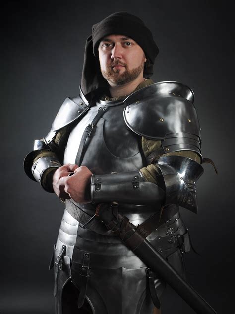 Steel mastery. 竄ｬ210. Black tabard with a helmet, white lilies and crosses. Tabard is a surcote, which seems quite simple, but absolutely indispensable in SCA, HEMA, LARP and reenactment events, stage performances and medieval festivals. You may order tabard sewn by two ways. 