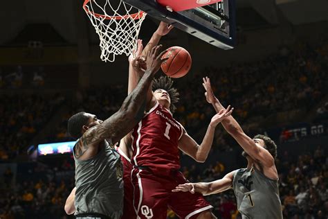 West Virginia guard Erik Stevenson (10) shoots over Iowa State guard Tamin Lipsey during the second half of an NCAA college basketball game, Monday, Feb. 27, 2023, in Ames, Iowa.. 