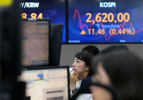 Stock market today: Asia shares mixed after Fed holds rates steady and hints of hikes ahead