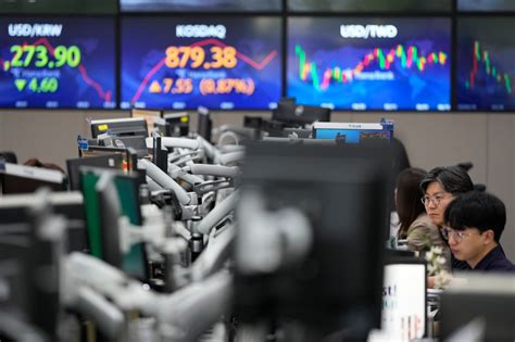 Stock market today: Asia shares rise as Fed holds rates steady while hinting of hikes ahead