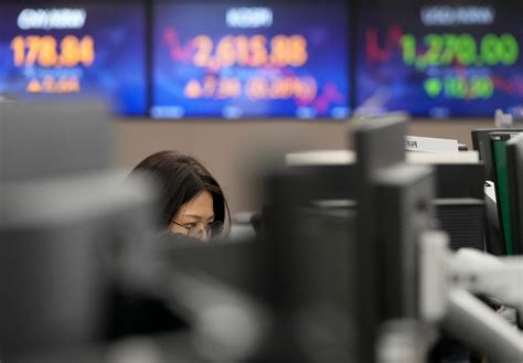 Stock market today: Global shares mixed after Fed holds rates steady but hints of hikes ahead