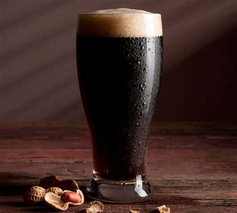 Stout beer. English Stout. Learn more about the English Stout style of beer. Stouts are typically dark brown to pitch black in color. A common profile among Stouts, but not in all cases, is the use of roasted barley (unmalted barley that is kilned to the point of being charred) which lends a dry character to the beer as well as a huge roasted flavor that ... 