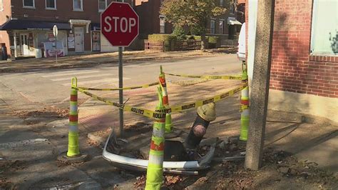 Street corner remains littered with debris from car crash two weeks later
