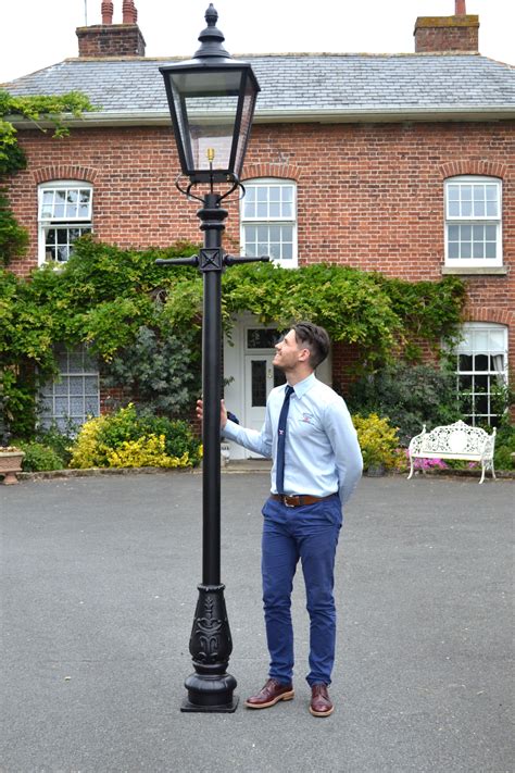 Street lamp post. Victorian Solar Lamp 2 Downward Hanging 13 Light 90" Post and Lantern Set. 90 inch high lantern post featuring two downward hanging lamps. Additionally, it features construction made of cast aluminum which is weather-resistant, and powder-coated black finish. The lamps have two levels of brightness. 