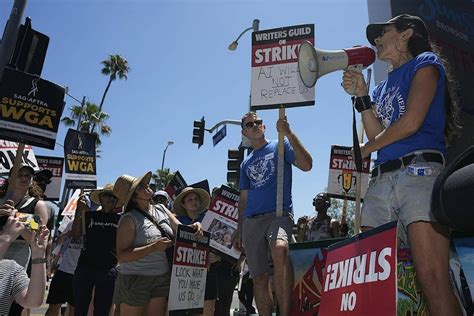 Striking actors begin picketing alongside writers in fight over the future of Hollywood