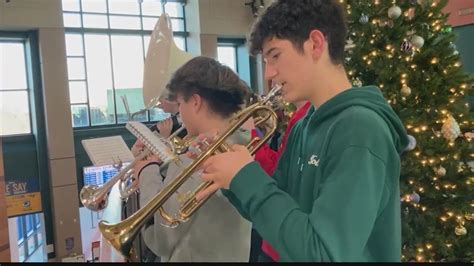 Student band performs for travelers at train station