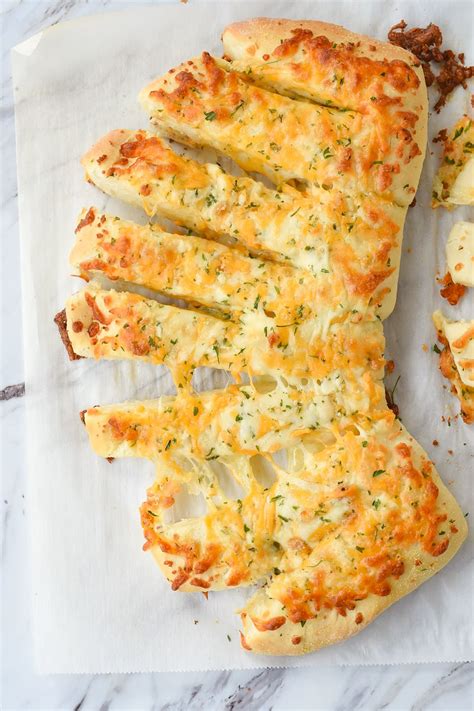 Stuffed cheesy bread. Preheat oven to 350 degrees. Combine softened butter, garlic, basil, and salt until well combined. Slice bread almost all the way through, leaving each slice slightly intact. Spread both sides of bread with butter mixture. (depending on the size of your bread you may have butter left over). 