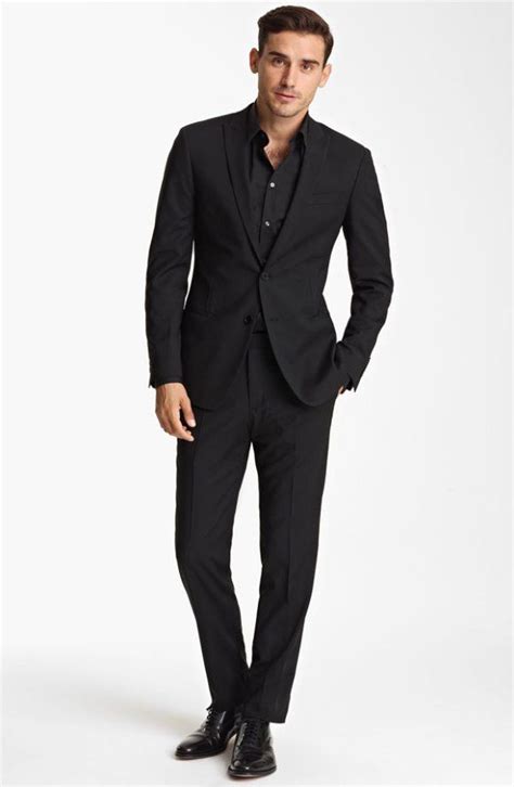 Suit black shirt. Black on black is typically an eye-catching style as fabulous as in 80s fashion. 1. A matte black suit paired with a glossy black shirt can create an interesting contrast. 2. A black satin pocket square, pair of cufflinks, and … 