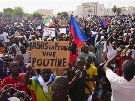 Supporters of Niger’s coup march through the capital waving Russian flags and denouncing France