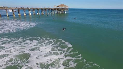 Guide to the best surf conditions for Cocoa Beach Pier including swell direction, wind, and tide, plus travel details like best season, water quality and parking..