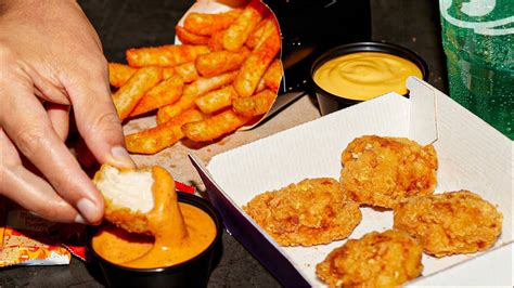 Taco bell chicken nuggets. By itself with no cheese sauce, the chicken chips are still 330 calories, 20 grams of fat (3 grams saturated), 890 mg of sodium, 24 grams of carbs, 1 gram of fiber, 0 grams of sugar, and 13 grams of protein. Compare that to McDonald's 6-piece chicken McNugget, which has only 270 calories, 16 grams of fat (2.5 grams saturated), 510 mg of sodium ... 