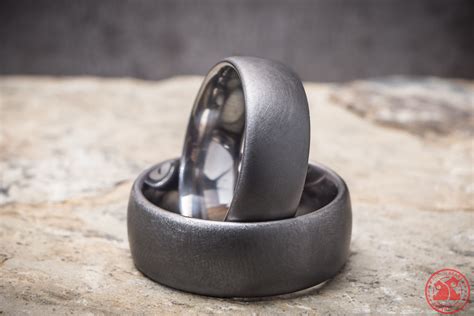 Tantalum rings. This Darkened Tantalum ring Features:- 6mm Width- Domed Shape- Satin Finish- Tree DesignCombining the rugged look of an industrial metal with the ... 