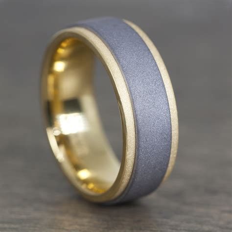 Tantalum wedding band. All Tantalum wedding bands are crafted with Benchmark’s comfort fit design so regardless of any activity, it will comfortably stay in place. Represent your individual style, with a detailed design from Tantalum. The two-tone wedding bands bring out the best features of fine metals such as grey tantalum and black platinum for a … 