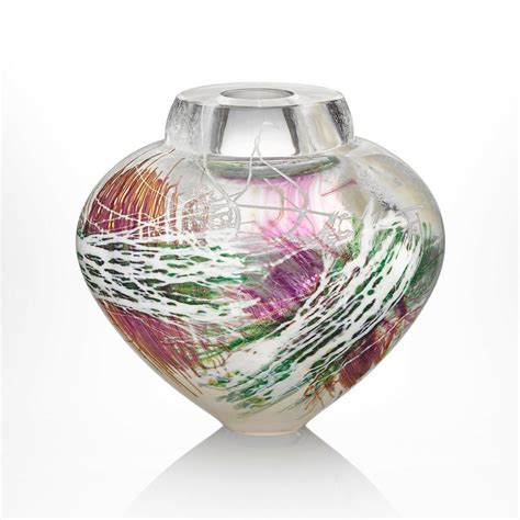 Tapestry emperor bowl. Interwoven layers of glass cane arc across this stunning blown glass vessel, evoking the colors of a summer meadow—green and saffron grasses, purple heather, and white clover. This blown glass vessel was hand shaped while hot on the pipe. Dimensions: 7″x7"x7" 