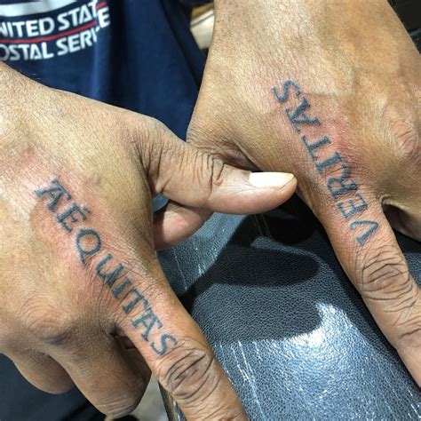 Tattoos from boondock saints. The Boondock Saints grossed $30,471 in the domestic market. What text is the boondock saints' aequitas and veritas tattoos in? it's in latin. it means truth and justice 