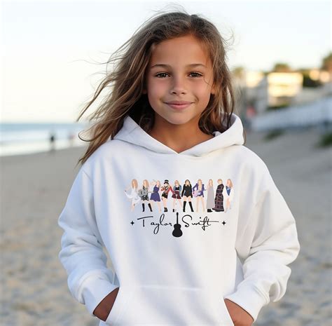 Taylor Swift Christmas Hoodie. S M L XL Width, in 16.93 18.11 18.90 20.08 Length, in 21.26 22.44 24.02 25.59 Sleeve length (from center back), in 26.50 27.76 30.24 32.99 The youth blend hooded sweatshirt is made of ultra …. 
