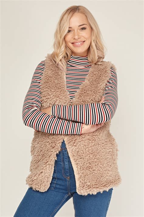 Teddy gilet women. Get cosy in this season's must-have teddy coats. Warm, fluffy teddy bear coats for women in black, brown and pink colours. Next day delivery and free returns available. 