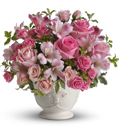Telaflora - Includes pink roses, tulips, carnations and waxflower, accented with fresh pitta negra and variegated pittosporum. Delivered in a lovely glass vase.