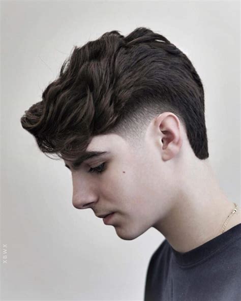 Drop Fade with Choppy Textured Top. This hair cut incorporates a tight drop fade that transitions into a bald fade. The top of the hair is kept longer and more messy for a more textured style. The fringe section at the front is also kept a little longer to hang forward on the forehead. 13 / 48.