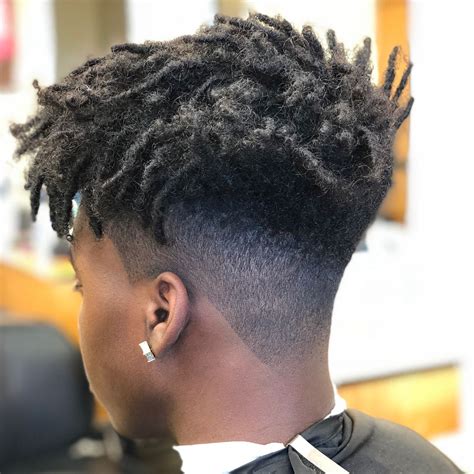 A nice temple fade is best for black men with dreadlocks. The long hairstyle with dreads are half pulled back to show off where the nice style is on the side. The lighter brown mixes well with the natural black color of these dreads to add a lot of dimension and a visually interesting element. Short Temple Fade . 