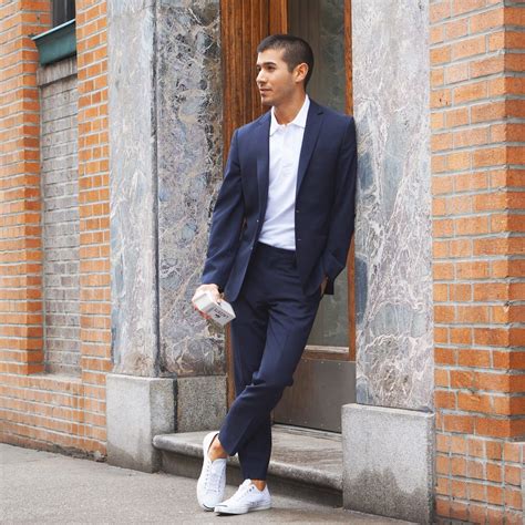 Tennis shoes to wear with suits. Sneakers are perfectly acceptable to wear with suits, even athletic ones (especially minimal classics like these). You'll be walking on air, and if you wanted to, you could sprint on it. 6/9 