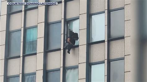 Tense moments when man threatens to jump off highrise in NYC as FBI attempt to serve warrant