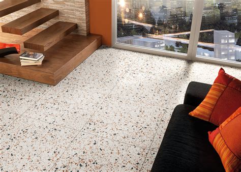 Terrazzo tile. Terrazzo glass tiles are a fusion of recycled glass fragments, binding agents, and artistry. Each tile boasts a unique mosaic pattern, a result of varied glass colors and sizes. Their polished surface reflects light brilliantly, and their diverse color options offer endless design potential. 