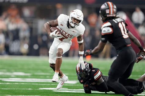 Texas blasts Oklahoma State 49-21 to win Big 12 title, Longhorns await CFP fate as other title games unfold