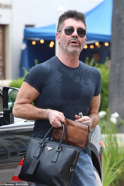 The Sweat Factor! Simon Cowell is drenched in sweat stains in a …