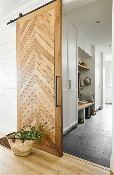 The barn door. Since the Masonite 36 in. x 84 in. 1 Panel K-Bar Knotty Pine Wood Interior Sliding Barn Door Slab with Hardware Kit will provide 1 3/4" of space from the wall, based on the information provided this door would clear the door frame. 