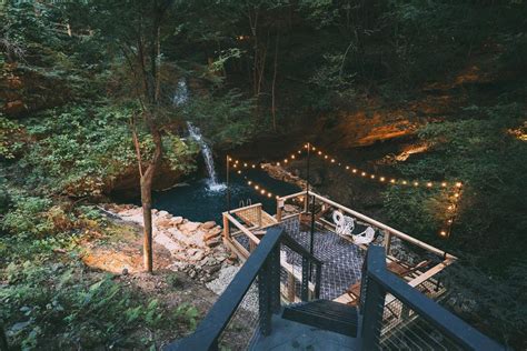 Hidden gems truly abound in the Buckeye State. Hiding in one of the most scenic regions of Ohio, The Cliffs at Hocking Hills is a luxury cabin getaway that features a heated waterfall swimming hole, secret passageways, sweeping views, a massive hot tub and so much more. Newly renovated and able to sleep up to 18 guests, this Hocking Hills waterfall cabin truly is the ultimate getaway in Ohio.. 