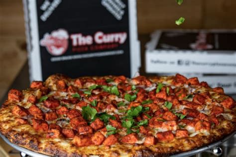 The curry pizza company. Curry sauce, cheese, bell pepper, red onion, diced tomatoes, masala paneer, green onion, cilantro 