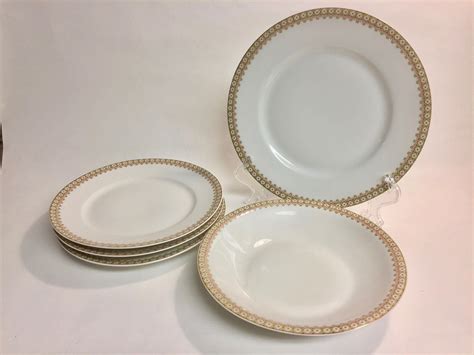 These lovely 10-1/4 dinner plates were made in Limoges, France by Theodore Haviland in the popular Shalimar pattern. Shalimar, in production between 1971 and 1992 is in the striking Louis XV shape with gold trim set inside the rim and a textural ribbed verge. The white ground is accented by sprays. 
