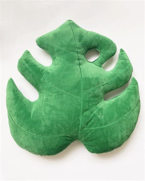 This Monstera Leaf Pillow adds a grace of paradise to your room without