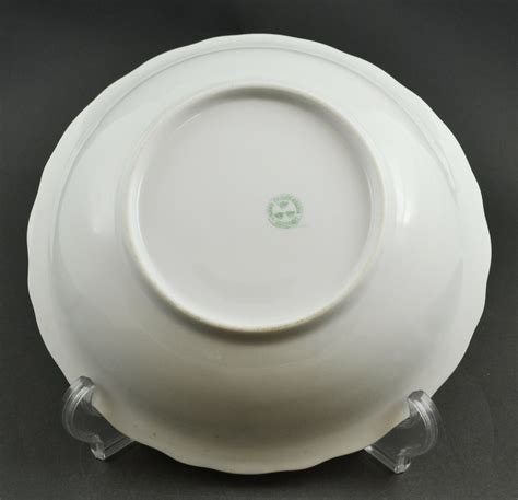 Identify crown marks on fine china by looking at the bottom of the piece for the maker’s mark containing a crown icon. The crown mark is either detailed or a basic design, the latter as seen in Capodimonte porcelain made in the Royal Factor.... 