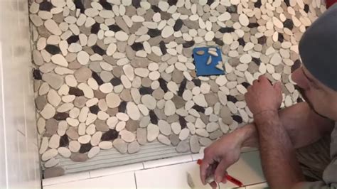 Most pebble or mosaic tile installations are done by 