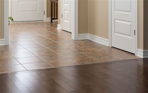Tile to hardwood transition. Pro: Cost of Material. As always, price can be a big factor when weighing wood-look versus true wood options. “Wood-look tile is significantly cheaper in comparison to true hardwood floors,” says Corona. “Hardwood floors can cost up to $15 per square foot while tile can range from $1.50-$5 per square foot.”. 