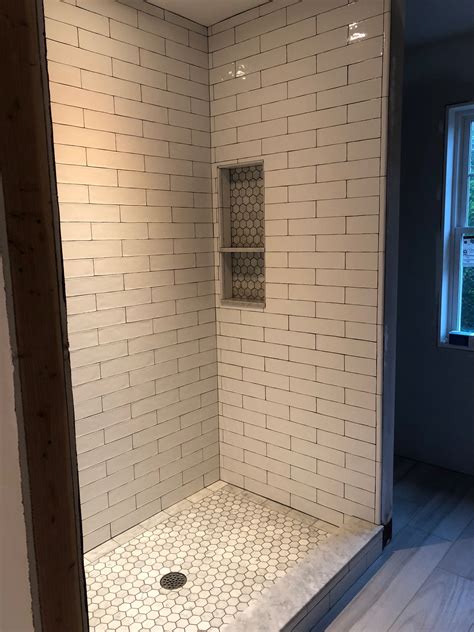 Tiling a shower. This video demonstrates how to tile a shower corner bench. The tile installed is a 12x24 porcelain for the walls and bench.The tile trim edging profile used ... 