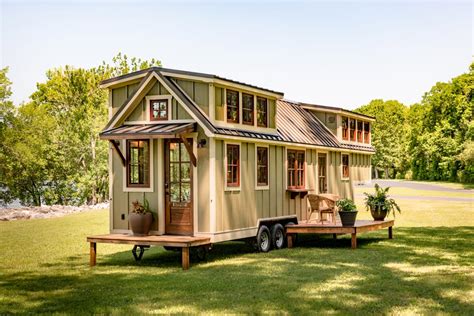Here is another worth exploring, the $89,000 Denali. This lovely tiny house includes plenty of loft space and a side and rear door. The rear door opens out onto a little porch with an awning. You can also put up a side porch for even more outdoor space. The Denali looks quite at home in its surroundings.. 