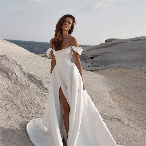 Timeless wedding gowns. 09-Jan-2023 ... A soft and sweet off-the-shoulder tulle gown from The Bridal Studio primps for a day of romance. The sheer corset bodice accented by Swarovski ... 