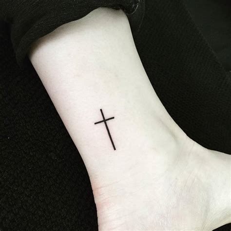 Tiny christian tattoos. This Christian cross tattoo is simple yet very elegant. One can even make it a tiny cross tattoo design or add it to the patchwork tattoo designs. The way the designs are made, it looks like gems have been added to the cross tattoo designs. This tattoo can also be made as a cross arm tattoo or a cross forearm tattoo design. The Women Cross Tattoos 